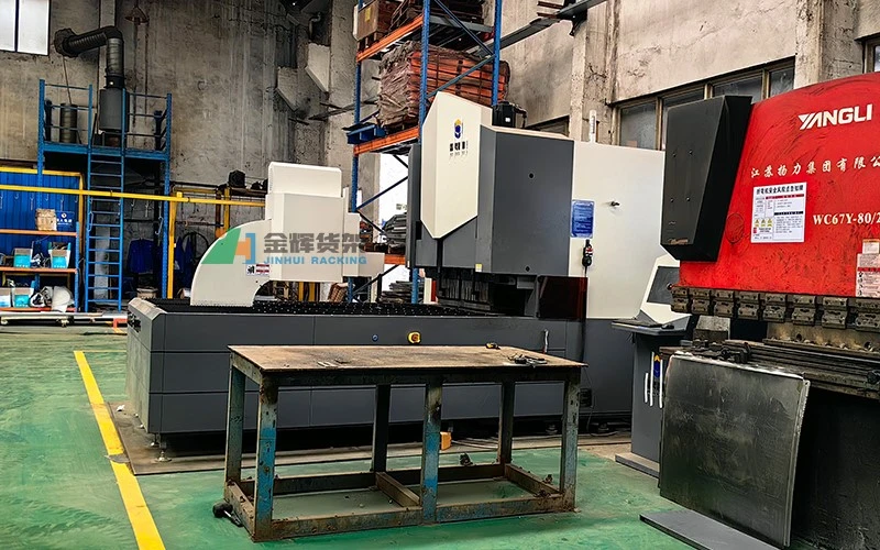 CNC punching machine processing metal sheets in workshop